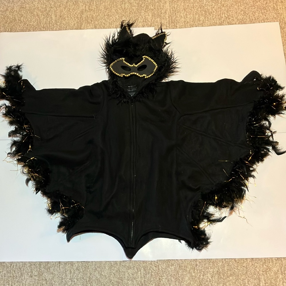 Original modified with gold jewels, threads, black feathers, and mask